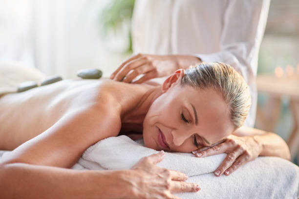 Shot of a mature woman getting a hot stone massage at a spa