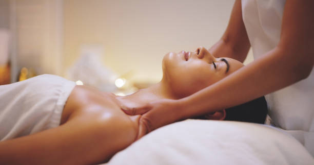 Shot of a beautiful young woman enjoying a shoulder massage at a beauty spa
