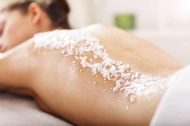 Picture of beautiful woman getting exfoliation treatment in spa